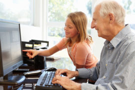 42109313 - senior man and granddaughter using computer